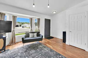 Living area with wood finished floors and baseboards