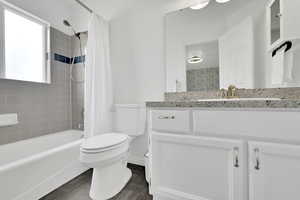 Full bathroom featuring shower / bathtub combination with curtain and vanity