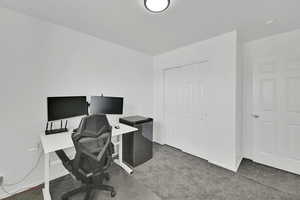 Home office with baseboards and carpet floors
