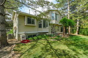 Rear view of house with a yard
