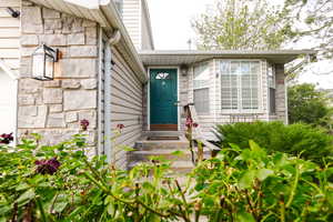 Entrance to property with stone siding