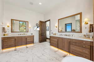 Bathroom with two vanities and marble look tiles