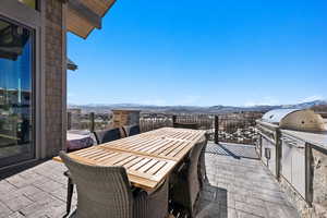 View of patio with outdoor dining space, an outdoor kitchen, and a mountain view