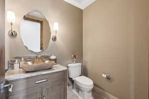 Half bath with vanity and tile patterned floors
