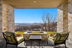 View of patio with a fire pit and a mountain view