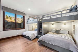 Bedroom with wood finished floors and recessed lighting