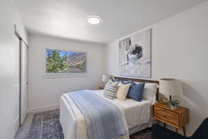 Carpeted bedroom with a closet and baseboards
