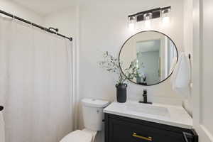 Bathroom with vanity and curtained shower