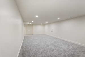 Finished basement with recessed lighting and carpet floors