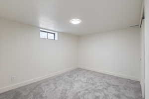 Basement with carpet and baseboards