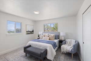 Bedroom with multiple windows and carpet floors