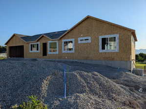 Property under construction featuring an attached garage