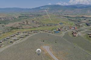 Aerial view of property and surrounding area with a mountainous background