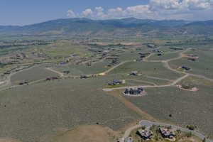 Aerial view of property's location with a mountain backdrop
