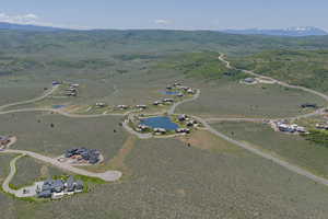 Aerial view of property's location featuring a water and mountain view