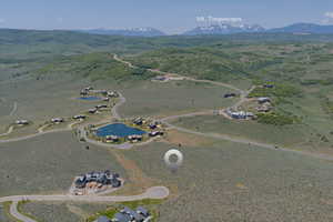 Aerial overview of property's location featuring a water and mountain view
