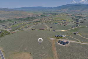Aerial view of property and surrounding area with mountains