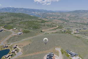 Aerial view of property and surrounding area featuring a water and mountain view