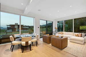 Sunroom / solarium featuring a mountain view and beamed ceiling