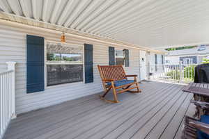 Wooden porch featuring area for grilling