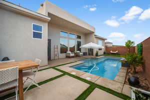 View of swimming pool with a patio area, a fenced backyard, an outdoor living space, and outdoor dining area