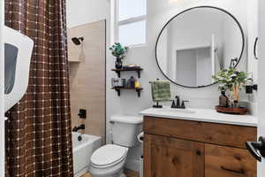 Full bath with vanity and shower / bath combination with curtain