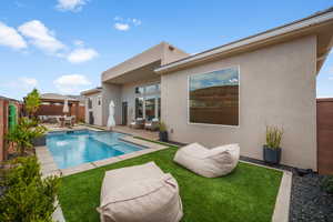 View of pool featuring an outdoor living space, a gazebo, a fenced backyard, and a patio