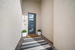 View of exterior entry featuring stucco siding