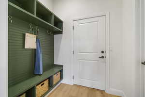 Mudroom featuring light wood-type flooring and baseboards
