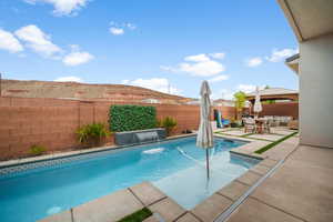 View of swimming pool featuring a fenced backyard, a patio, and outdoor lounge area