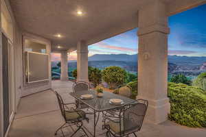 View of patio with a mountain view and outdoor dining area