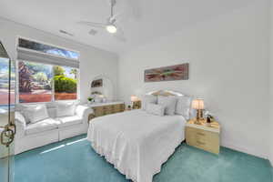 Carpeted bedroom with crown molding and ceiling fan