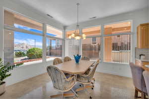 Dining room featuring a chandelier, a mountain view, and crown molding