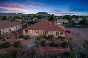 View of front of house with a tile roof, a mountain view, a porch, and a residential view
