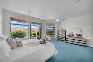 Carpeted bedroom with ornamental molding, ceiling fan, and access to exterior