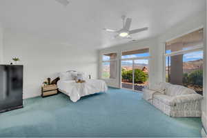 Bedroom featuring access to outside, carpet floors, ceiling fan, ornamental molding, and a mountain view