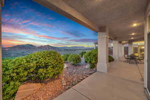 Patio terrace at dusk featuring a mountain view and a patio area