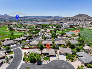 Aerial perspective of suburban area featuring a golf course and a water and mountain view