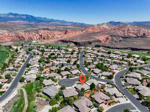 Aerial view of property's location with a mountainous background and nearby suburban area