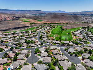 Aerial perspective of suburban area featuring mountains and a local golf course