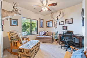 Office area featuring wood finished floors and ceiling fan