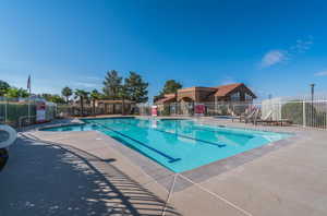Community pool with a patio