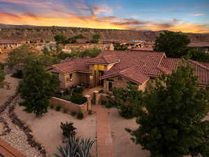 View of front facade featuring a tiled roof, stone siding, stucco siding, and a mountain view