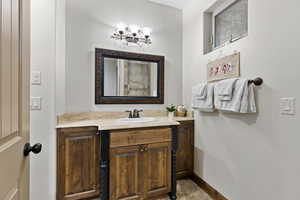 Bathroom featuring vanity and baseboards