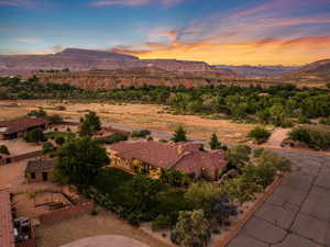 Aerial view of property and surrounding area featuring mountains
