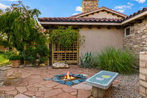 View of patio featuring an outdoor fire pit