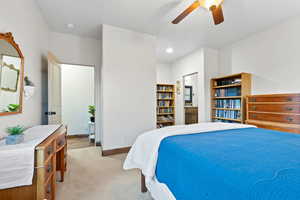 Bedroom featuring light carpet, a ceiling fan, recessed lighting, and ensuite bath