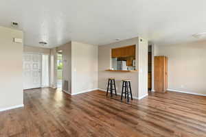 Unfurnished living room featuring wood finished floors and a textured ceiling