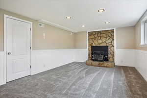 Downstairs family room with fireplace and wainscotting