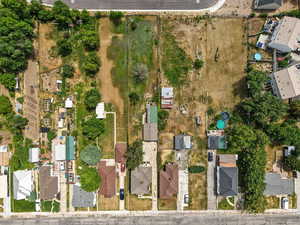 Aerial view of property and surrounding area with nearby suburban area